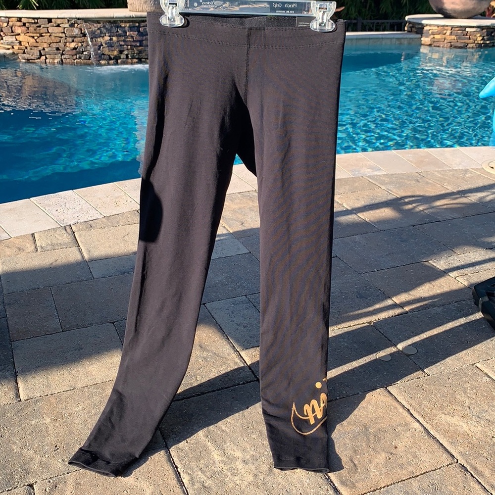 Nike leggings. Black with gold logo. Size small